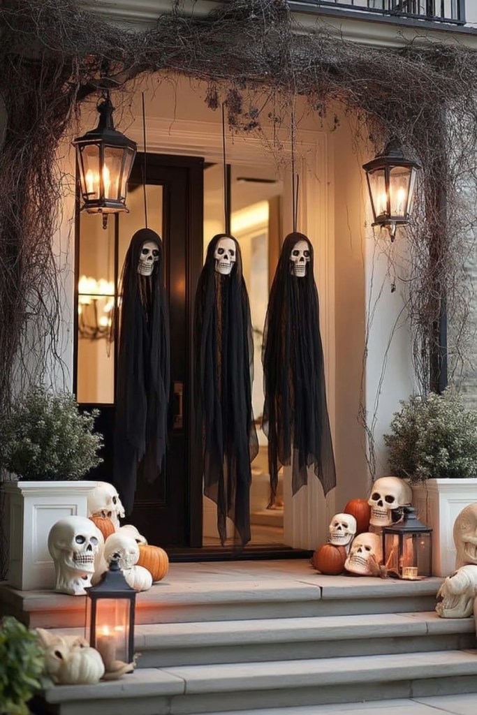 Spooky Ghost Trio With Pumpkins and Skulls-halloween front porch ideas-loves from bet