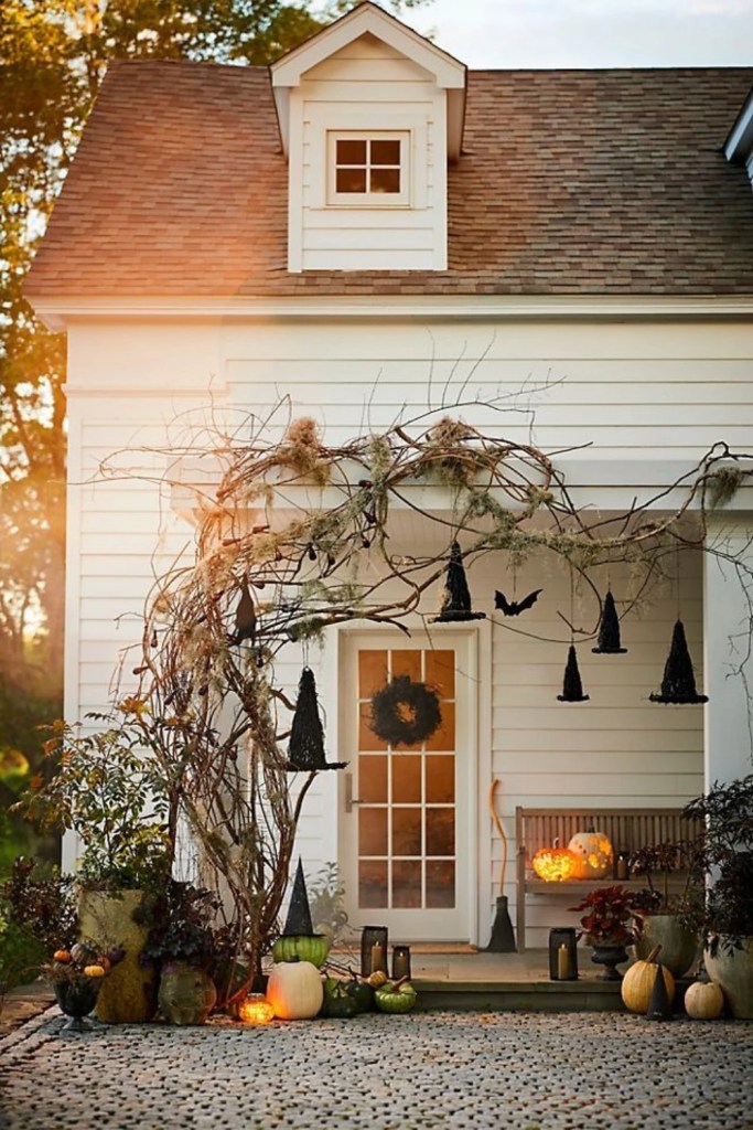 Cottage Doorway Wrapped in Witch Hats and Lanterns-halloween front porch ideas-loves from bet