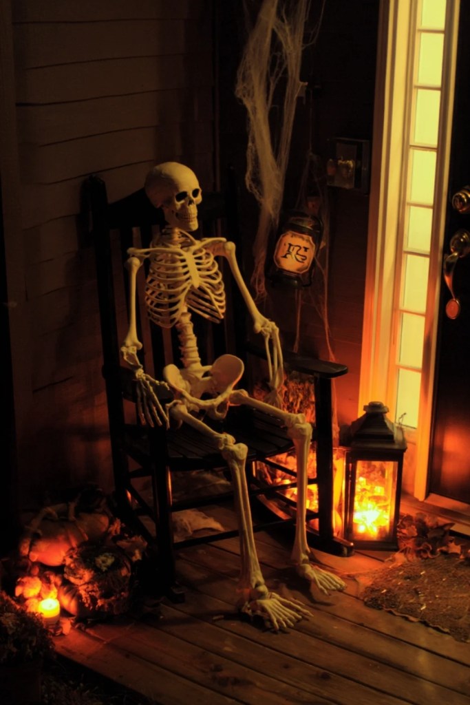 Skeleton in Rocking Chair With Lantern Glow Porch-halloween front porch ideas-loves from bet